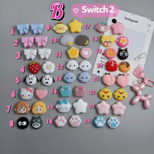 May include: A collection of colorful resin charms in various shapes, including bows, stars, and cartoon characters. The charms are in shades of pink, blue, yellow, and white, with some featuring detailed designs.