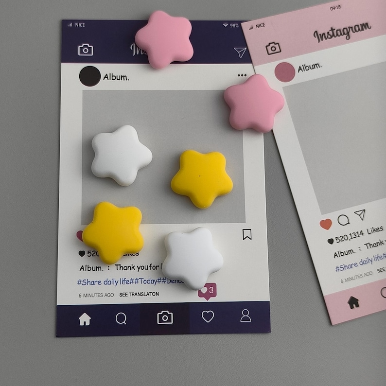 May include: A collection of star-shaped magnets in pink, white, and yellow, scattered on and around Instagram-themed photo frames. The frames are white and pink, with social media interface elements. The text "Album. Thank you for!" is visible.
