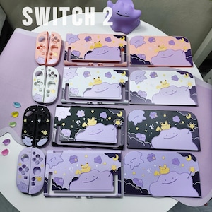 May include: A collection of four Nintendo Switch console protective cases and matching controller covers featuring a purple Ditto character design with a yellow creature, stars, and moons. The text SWITCH 2 is visible at the top.