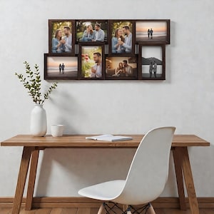 May include: A dark brown multi-opening collage picture frame featuring seven rectangular slots of varying sizes and orientations. The frame is mounted on a wall and contains photographs of a couple in various settings, including beaches and indoor scenes.