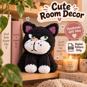 May include: A black and white crocheted cat plush toy with green eyes, a pink nose, and purple inner ears. The cat has a white muzzle and white paws. Text in the image includes "Cute Room Decor," "Handmade Gift Idea," and "Digital Pattern Only."