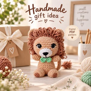 May include: A crocheted lion amigurumi with a tan body, a brown yarn mane, black safety eyes, a white muzzle, and a small green bow tie. The image includes the text "Handmade gift idea" and "Digital PDF pattern" in a circular badge.