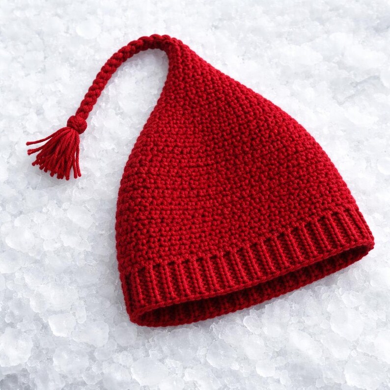 May include: A vibrant red knit hat with a long, curved tip and a tassel. The hat features a ribbed brim and a textured, close-knit design. This festive hat is perfect for winter wear.
