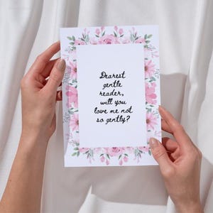 May include: A floral greeting card with a white rectangular center and a border of pink roses and green leaves. The card features the text "Dearest gentle reader, will you love me not so gently?"