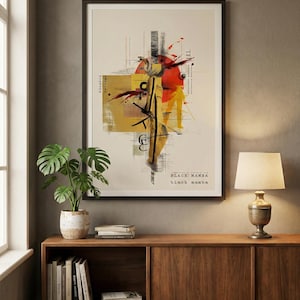 May include: Framed art print with abstract design in yellow, red, and black. The artwork features geometric shapes, lines, and the text "BLACK MAMBA" at the bottom. The print is displayed on a wooden cabinet with a lamp and a potted plant.