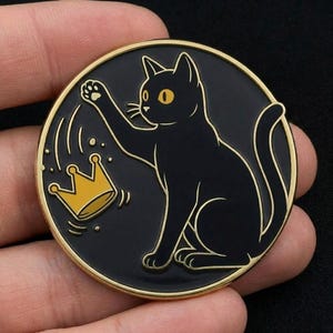 May include: A black cat with yellow eyes and a gold outline, reaching for a gold crown on a black circular coin. The coin has a gold rim. The cat is the central focus of the design.