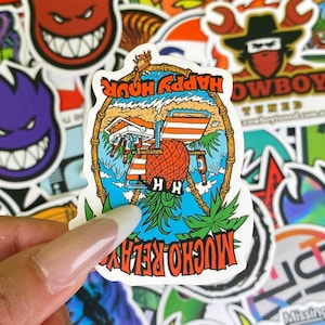 May include: A sticker with a tropical beach scene, featuring a pineapple, beach chair, and the words "Happy Hour" and "Mucho Relax". The sticker has a bamboo frame and palm trees, with a blue and orange color scheme.