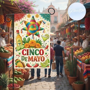 May include: A Cinco de Mayo garden flag with a colorful star-shaped pinata, tequila bottle, margarita, and the text "Cinco de Mayo." The flag is decorated with images of tacos, limes, and chili peppers. The background shows a bustling marketplace.