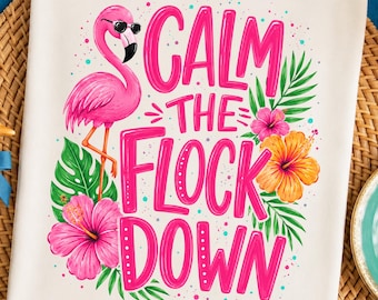 May include: A cream-colored t-shirt featuring a graphic of a pink flamingo wearing black sunglasses, surrounded by green tropical leaves and vibrant pink and orange hibiscus flowers, with the text "CALM THE FLOCK DOWN" in bold pink letters.