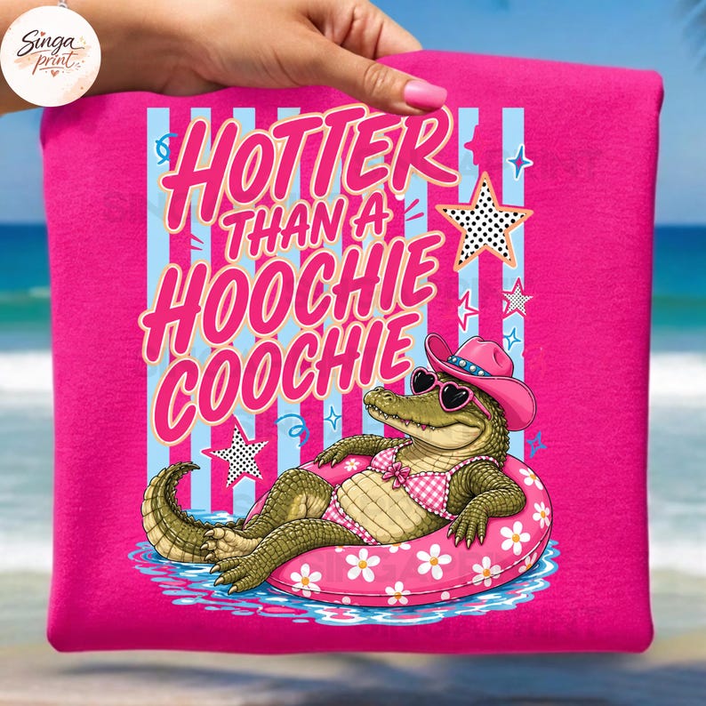 May include: Hot pink t-shirt with the text "Hotter Than a Hoochie Coochie" in pink and white. The graphic features an alligator wearing sunglasses, a pink cowboy hat, and a pink floral inner tube.