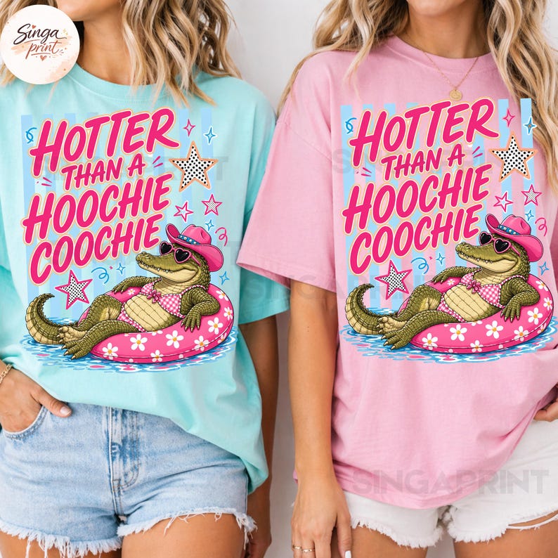 May include: Two t-shirts, one light blue and one pink, each featuring a graphic of an alligator in a pink floatie, wearing a cowboy hat and sunglasses. The text on the shirts reads "HOTTER THAN A HOOCHIE COOCHIE".