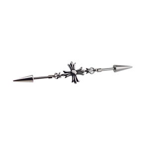 May include: A silver industrial barbell earring with a cross design in the center and a cone-shaped end on each side. The jewelry is made of a shiny metal and is set against a white background.