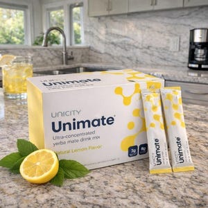 May include: A box of Unimate ultra-concentrated yerba mate drink mix with natural lemon flavor. Two single-serving packets and a half lemon with mint leaves are next to the box. The box and packets are white and yellow.