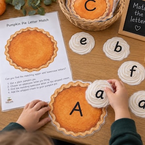 May include: A Pumpkin Pie Letter Match educational activity set featuring a printed instruction sheet, laminated pumpkin pie cutouts with uppercase letters, and whipped cream dollop cutouts with lowercase letters for matching practice.