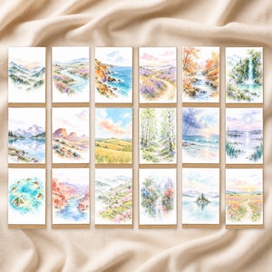 May include: A collection of eighteen rectangular greeting cards featuring watercolour landscape illustrations. The scenes depict diverse natural environments including mountain ranges, coastal cliffs, forests, waterfalls, rivers, and fields of wildflowers.