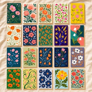 May include: A collection of twenty rectangular greeting cards arranged in a grid, each featuring distinct botanical illustrations with vibrant floral patterns, including poppies, daisies, and various stylised blossoms in diverse colour palettes.