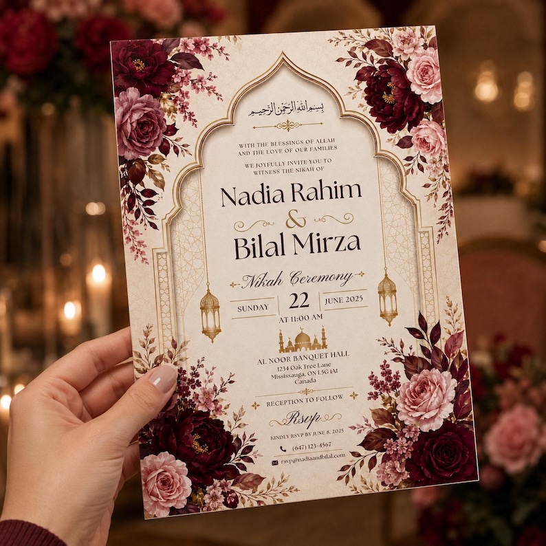 May include: A rectangular wedding invitation card featuring a cream background with an arched frame, gold line art of lanterns and a mosque, and deep burgundy and soft pink floral arrangements. The text details the Nikah ceremony for Nadia Rahim and Bilal Mirza on Sunday, June 22, 2025, at 11:00 AM at Al Noor Banquet Hall in Mississauga, Canada.