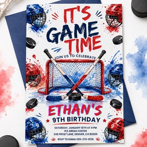 May include: A hockey-themed birthday invitation with a white background, featuring red and blue accents. The design includes a hockey net, crossed hockey sticks, helmets, and pucks. Text reads "It's Game Time" and details for Ethan's 9th birthday.