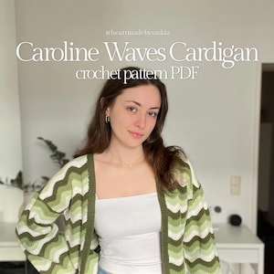 May include: A woman wearing a green, white, and brown chevron-patterned cardigan. The image text reads "Caroline Waves Cardigan crochet pattern PDF". The cardigan has long sleeves and a relaxed fit. The woman is wearing a white tube top and blue jeans.