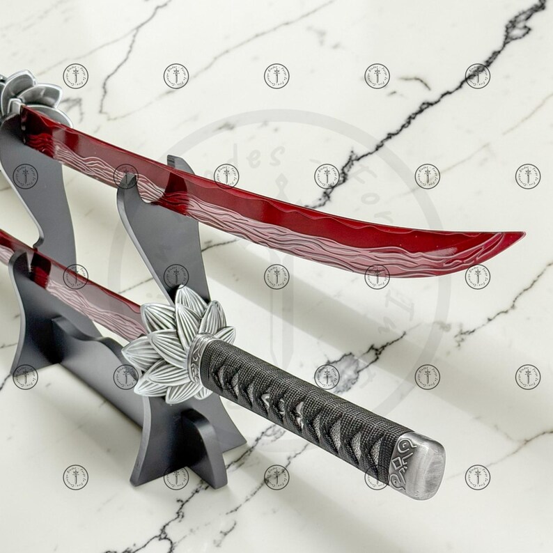 May include: Two decorative katana swords with red blades and black handles are displayed on a black stand. The blades have a unique wave pattern. The handles are wrapped in a textured black material, and the guard is silver with a floral design.