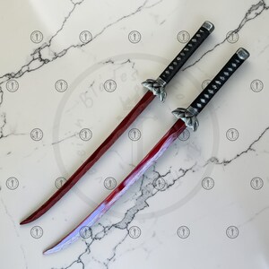 May include: Two katana swords with red blades and black handles. The handles have a diamond pattern and silver accents. The blades are curved and have a gradient of red to purple. The swords are displayed on a white marble surface.
