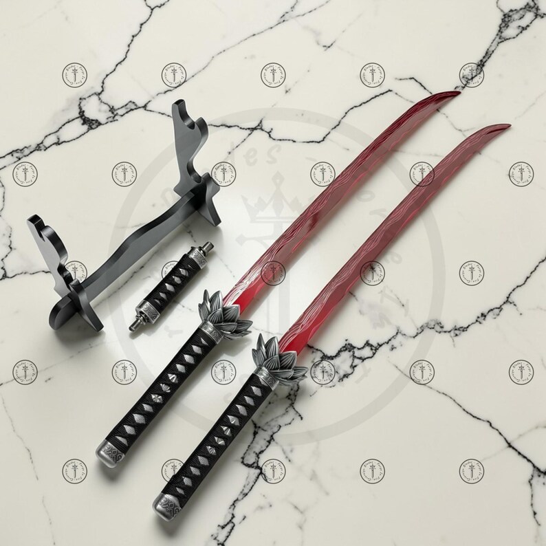 May include: Two red-bladed swords with black handles and silver accents, alongside a black display stand and a smaller, matching handle. The swords feature a lotus flower design at the base of the blade. The set is displayed on a marble surface.