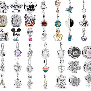 May include: A collection of silver charms and beads, featuring various designs. Charms include stars, hearts, and floral patterns. Beads have crystal and gemstone accents. Some charms have colorful enamel details, and others feature iconic characters.