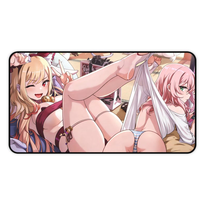 May include: Rectangular mousepad featuring anime-style illustrations of two women. One has blonde hair and is winking, while the other has pink hair. The mousepad has a black border and a white background.