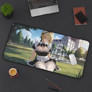 May include: A rectangular desk mat featuring an anime-style illustration of a blonde character in a black and white maid outfit. The character is positioned in a garden setting with a fountain and a large building in the background under a blue sky.