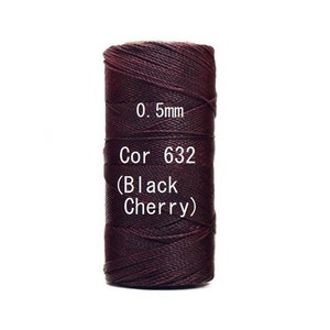 May include: A spool of 0.5mm thick waxed thread in a dark burgundy color. The label reads "Cor 632 (Black Cherry)".