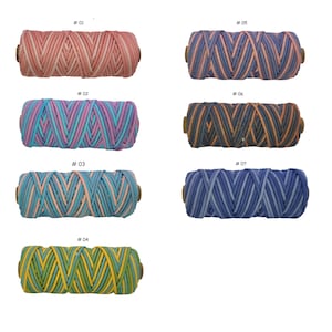 May include: Seven spools of colorful cord, each with a wooden core. The cords are in various color combinations, including pink, blue, green, and yellow. Each spool is labeled with a number from #01 to #07.