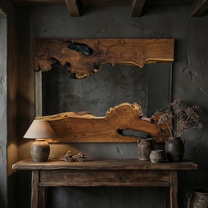May include: A large, rectangular wooden mirror with a live edge design. The mirror is framed by a thick, natural wood border with a unique, organic shape. A small lamp and vases sit on a wooden table below the mirror.