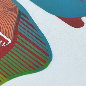 May include: Close-up of a white fabric with a colorful abstract design. The design features orange, teal, red, and green shapes. The artwork has a graphic, illustrative style, with a focus on bold colors and lines.