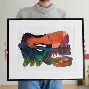 May include: Abstract art print in a black frame. The artwork features a colorful, layered design with orange, blue, green, and purple hues. The composition is a mix of organic and geometric shapes, creating a dynamic visual experience.