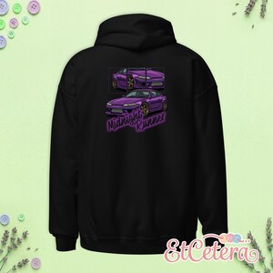 May include: Black hooded sweatshirt featuring a purple car graphic with the text "Midnight Runner." The graphic shows the car from multiple angles. The sweatshirt has a drawstring hood and a kangaroo pocket.
