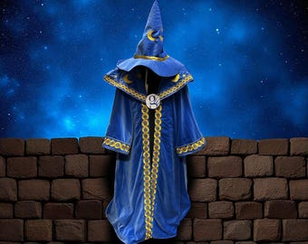 May include: A blue wizard robe and hat set with gold trim and crescent moon and star accents. The robe has a long, flowing design with a decorative gold chain down the front. The hat is tall and pointed, with a matching gold band.