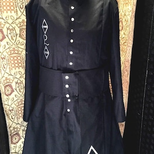 Band inspired coat including sash