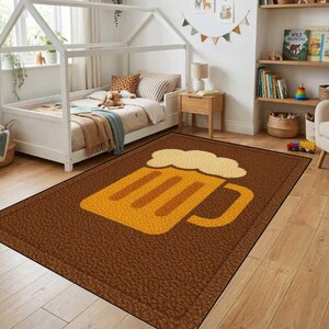 May include: A rectangular brown rug with a large yellow beer mug design. The rug has a textured surface and is placed on a wooden floor in a room with a bed and shelves.