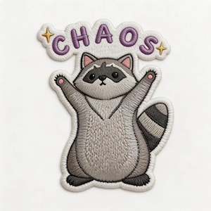 May include: An embroidered patch featuring a gray and white raccoon with its arms raised. Above the raccoon, the word CHAOS is stitched in purple letters, flanked by two small gold stars. The entire design has a white border and textured stitching.