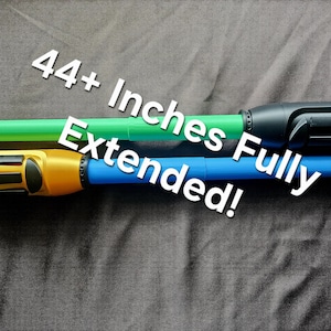 May include: Two extendable toy swords, one with a green blade and black hilt, the other with a blue blade and gold hilt. The text 44+ Inches Fully Extended! is printed across the image, indicating the length of the toys when fully expanded.