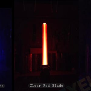 May include: Five vertical light-up blades in orange, blue, red, purple, and green. Each blade is labelled at the bottom with text: Clear Orange Blade, Clear Blue Blade, Clear Red Blade, Clear Purple Blade, and Clear Green Blade.