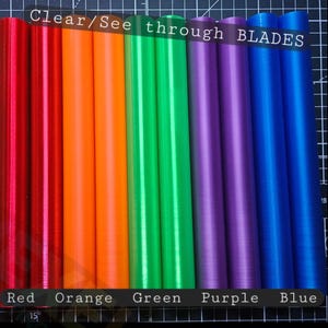 May include: A set of ten cylindrical blades arranged in a row, featuring a translucent finish in red, orange, green, purple, and blue. The text "Clear/See through BLADES" is visible at the top, with colour labels at the bottom.