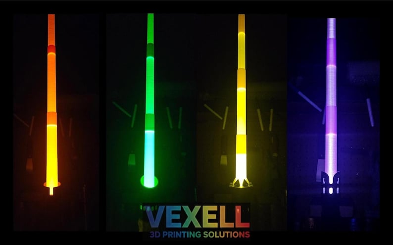 May include: Four vertical, glowing, collapsible light sabres in orange, green, yellow, and purple against a black background. The text VEXELL 3D PRINTING SOLUTIONS is printed in white and multi-coloured letters at the bottom centre of the image.
