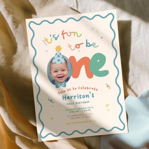 The image is a birthday invitation for a baby's first birthday celebration.