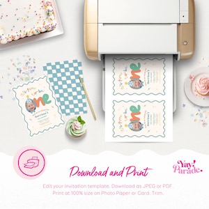 a birthday party setup with a cake, cupcakes, and a printer. There are also some printed invitations and a cake on the table.