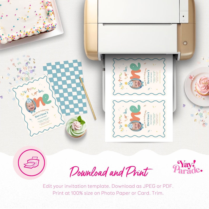 a birthday party setup with a cake, cupcakes, and a printer. There are also some printed invitations and a cake on the table.