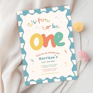 The image is a colorful invitation card for a one-year-old's birthday celebration.