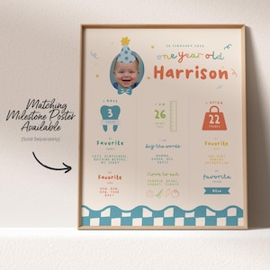 May include: A framed milestone poster for a one-year-old named Harrison, featuring a photo and details like height (26 inches), weight (22 pounds), and favorite things. The poster has a blue and white border and includes the text "Matching Milestone Poster Available".