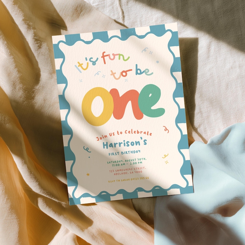 The image is a colorful invitation card for a first birthday celebration, featuring the text "It's fun to be One" and inviting guests to join the celebration.