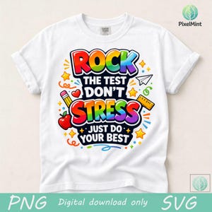 May include: White t-shirt with a colorful graphic that reads "ROCK THE TEST DON'T STRESS JUST DO YOUR BEST." The design includes a pencil, apple, stars, and a ruler. The shirt is made of a soft material.
